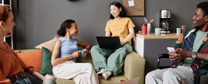 Four young coworkers sitting casually together.