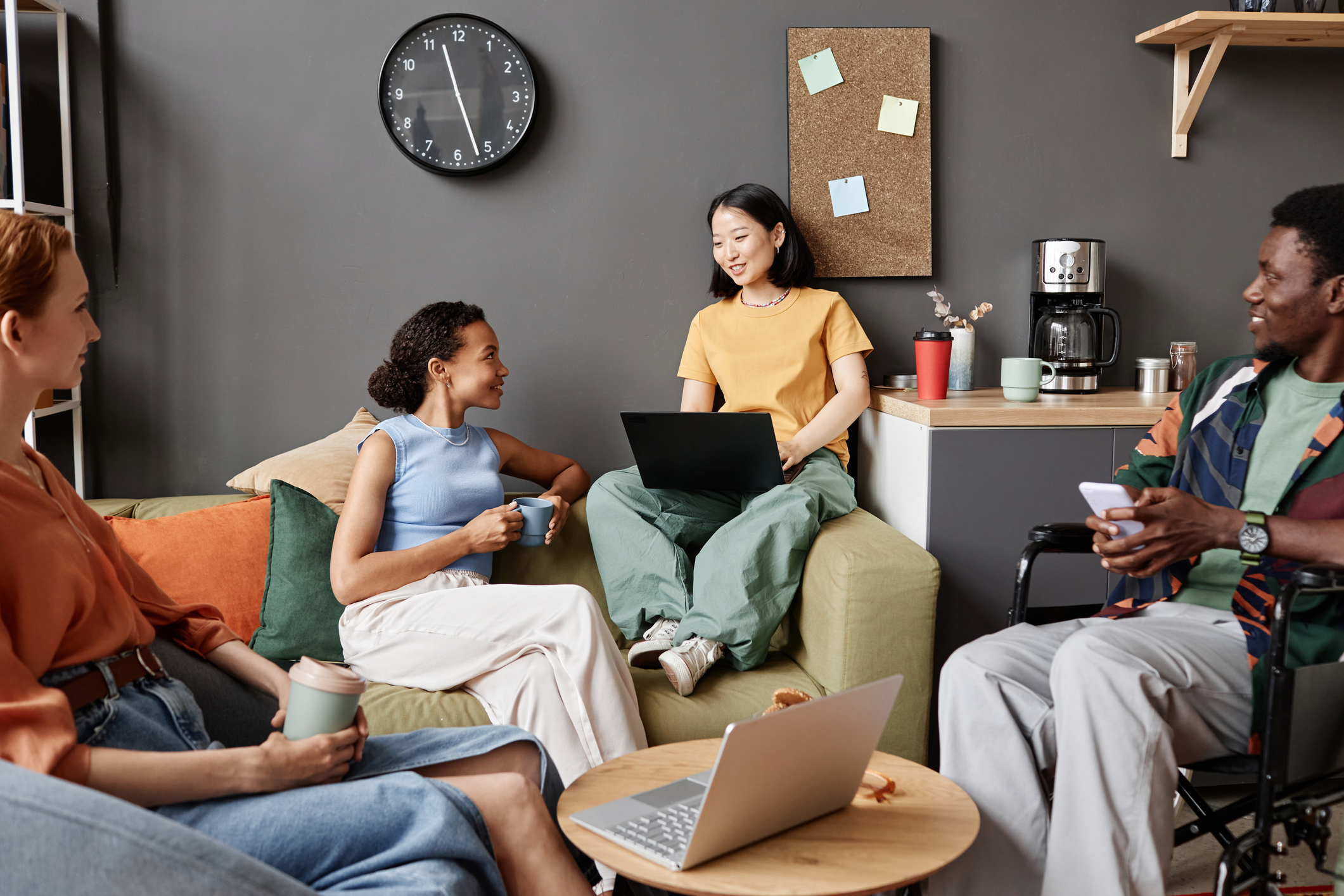 Four young coworkers sitting casually together.